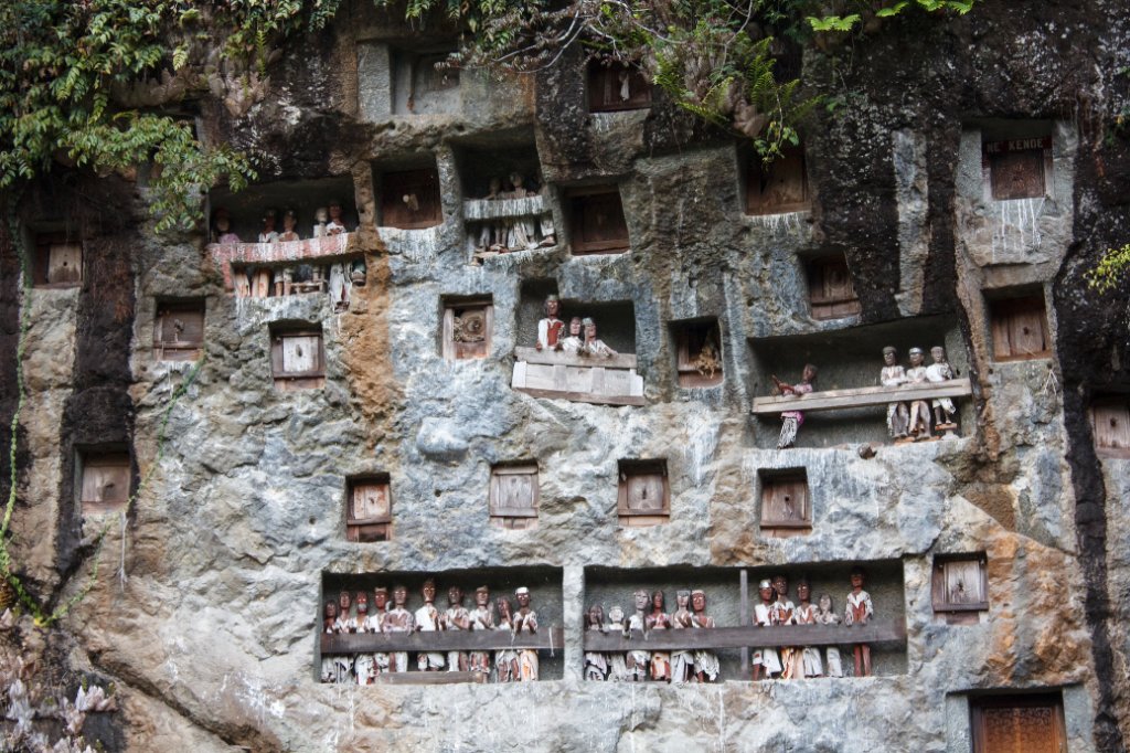 18-Rock tombs, guarded by tau-tau statues.jpg - Rock tombs, guarded by tau-tau statues